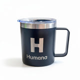 Black mug with 'H' and 'Humana' text on a white background