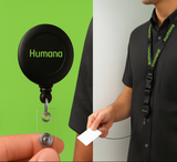 Black 'Humana' badge holder and lanyard on a green and white background